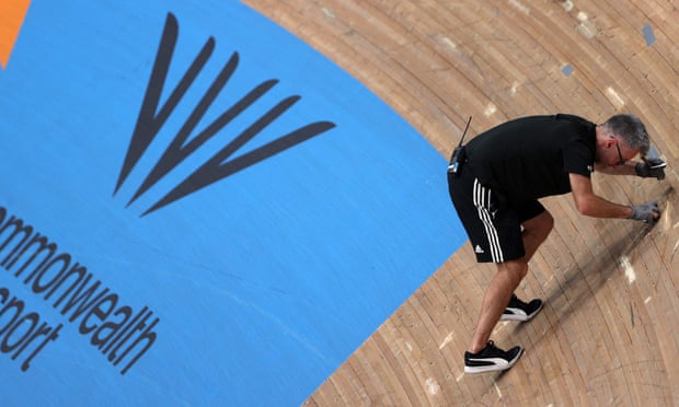 A track staff member fixes the track following the massive crash.