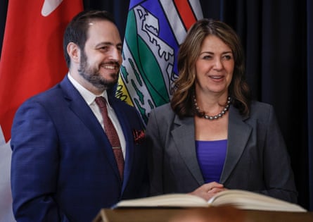 a man and a woman smile next to each other