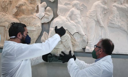 Conservators at the Acropolis Museum in Athens place the Parthenon fragment sent from Sicily.