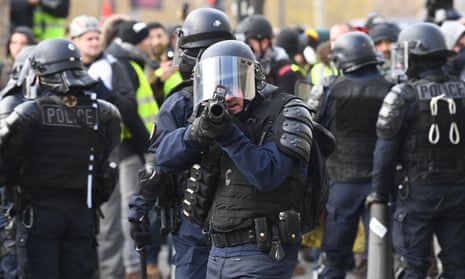 A riot police holds a flashball gun during a protest of Yellow vests