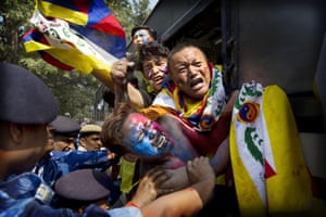 New Delhi, India. Soldiers force exiled Tibetan activists on to a police bus during a protest outside the Chinese embassy,marking the 59th anniversary of Tibetan Uprising Day