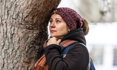 A woman cries as she looks at a destroyed residential building following a missile strike 4 days ago in the Ukrainian city of Dnipro on January 4, 2023.