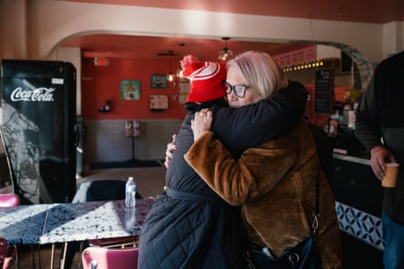 Two women embrace inside a bakery