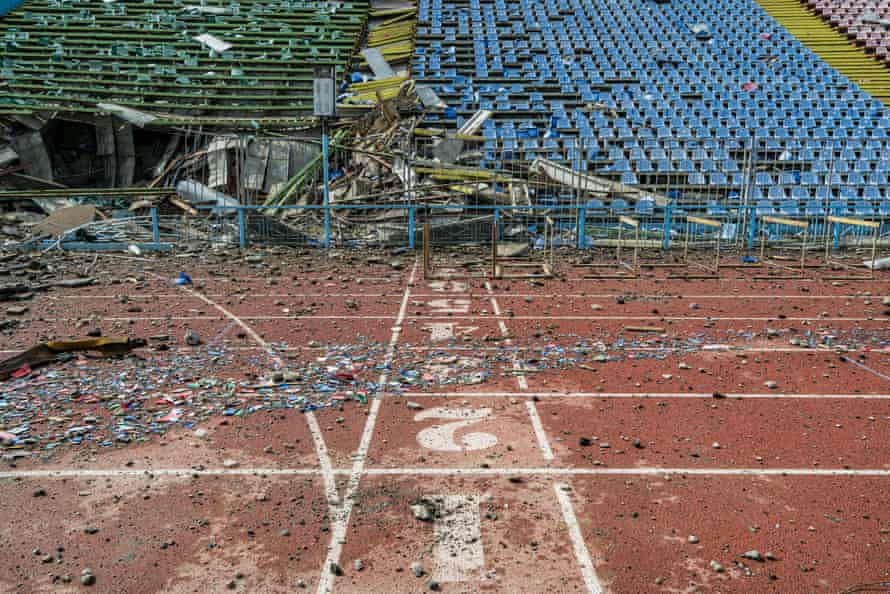 Russia-Ukraine war latest: Putin defends ‘noble’ invasion; alleged Mariupol chemical attack investigated – live | Ukraine 6 Aftermath of Russian shelling of the Yuri Gagarin stadium in Chernihiv.