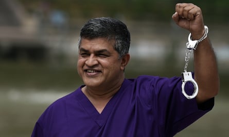 Malaysian cartoonist Zulkifli Anwar Ulhaque, popularly known as Zunar, poses with handcuffs prior to a book-launch event in Kuala Lumpur in February 2015.