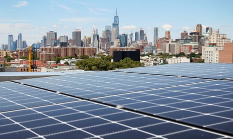 New York solar panels are seen along with a view of the neighborhood and lower Manhattan from the rooftop of Timber House, the city's first mass-timber condo building, in the Park Slope neighborhood of Brooklyn, New York.