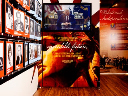 A man on a video screen inside a museum exhibit