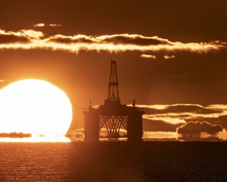 Sun rising behind a redundant oil platform moored in the Firth of Forth near Kirkcaldy, Fife.