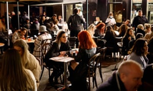 Customers enjoy drinks at tables outside the pubs and bars in the Soho area of London, on April 12, 2021 as coronavirus restrictions are eased across the country in step two of the government’s roadmap out of England’s third national lockdown.