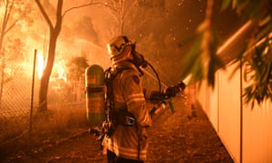 Firefighters tackling a bushfire close to homes in in Wattle Grove, Sydney, in April this year.