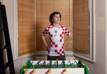 Max Stanić wearing the red-and-white Croatia World Cup shirt and standing behind a table football game at home 