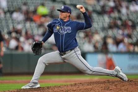 Tampa Bay Rays pitcher Garrett Cleavinger lunges forward on his right foot to throw the ball