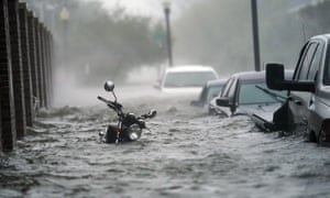 Floodwaters move on the street, in Pensacola.