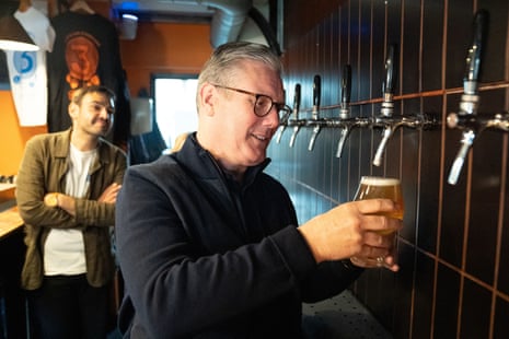 Labour party leader Keir Starmer helps to serve drinks during a visit to 3 Lock's Brewery in Camden, north London, on Saturday.