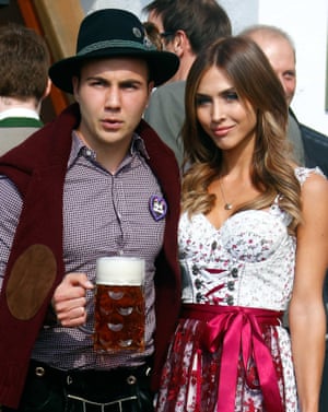 Mario Götze cuts a more serious figure as he poses with some beer and suede elbow patch alongside his girlfriend Ann-Kathrin Brommel