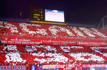 South Korean supporters hold up signs urging ‘Again 1966’ in reference to North Korea’s victory over Italy.
