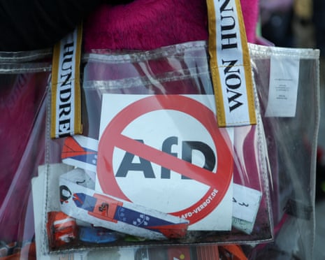 A demonstrator carries items signalling opposition to the far-right Alternative for Germany (AfD) party, during a protest the day after the party’s victory in state elections in Saxony-Anhalt at the Brandenburg Gate in Berlin, Germany.