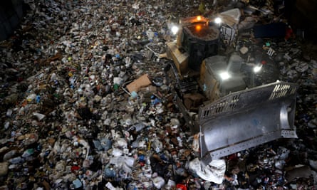 Bulldozer crushing plastic waste