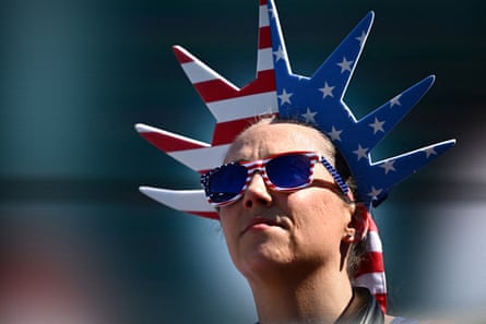 A US football team supporter wearing stars-and-stripes-patterned sunglasses and Statue of Liberty-style headgear