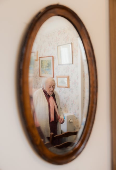 Margaret in the reflection of a bedroom mirror