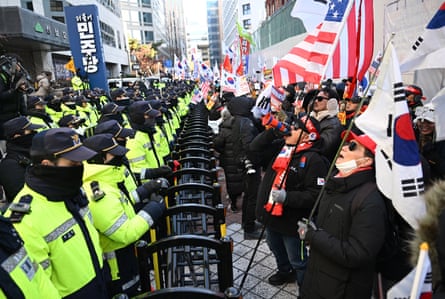 Supporters of Yoon Suk Yeol were vocal after his impeachment, pictured here shouting slogans in front of the ruling Democratic party headquarters on the first anniversary of the declaration of martial law.