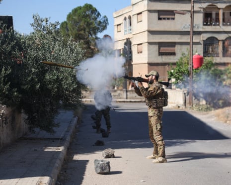 A Syrian security force member fires a shoulder-launched weapon amid clashes in the southern Sweida city on 16 July 2025.