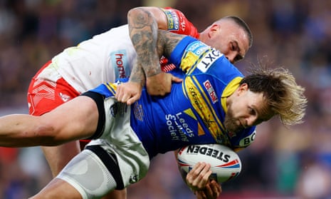 St Helens’ Curtis Sironen tackles Blake Austin of Leeds Rhinos during the 2022 Super League Grand Final match. In league, any tackle around or above the neck is deemed illegal. 
