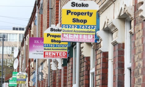 Signs for properties to rent outside of houses on a street