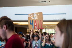 Jessica Carr of Wichita holds up a sign advocating for healthcare.