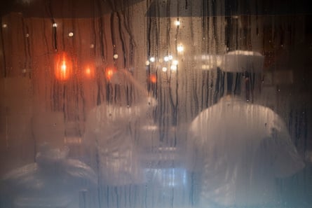 Chefs in whites working behind steamed up restaurant window