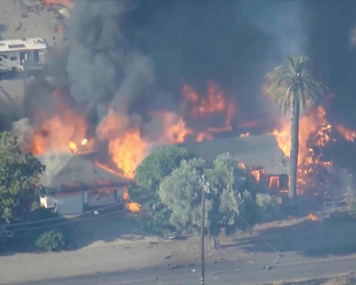 Smoke and flames rise above buildings