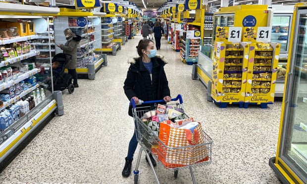 A customer shops for food items inside a supermarket store in east London in January.