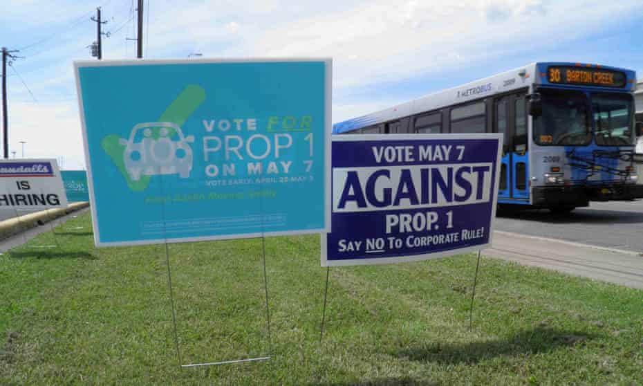 Campaign signs concerning a municipal vote over fingerprint requirements for ride-hailing companies such as Uber and Lyft are seen along a roadway in Austin, Texas, May 6, 2016.