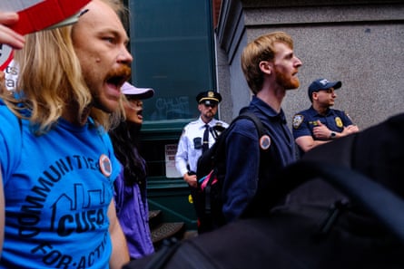 people chant while walking past police
