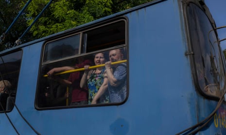 Two women look through the window of a tram in Kramatorsk