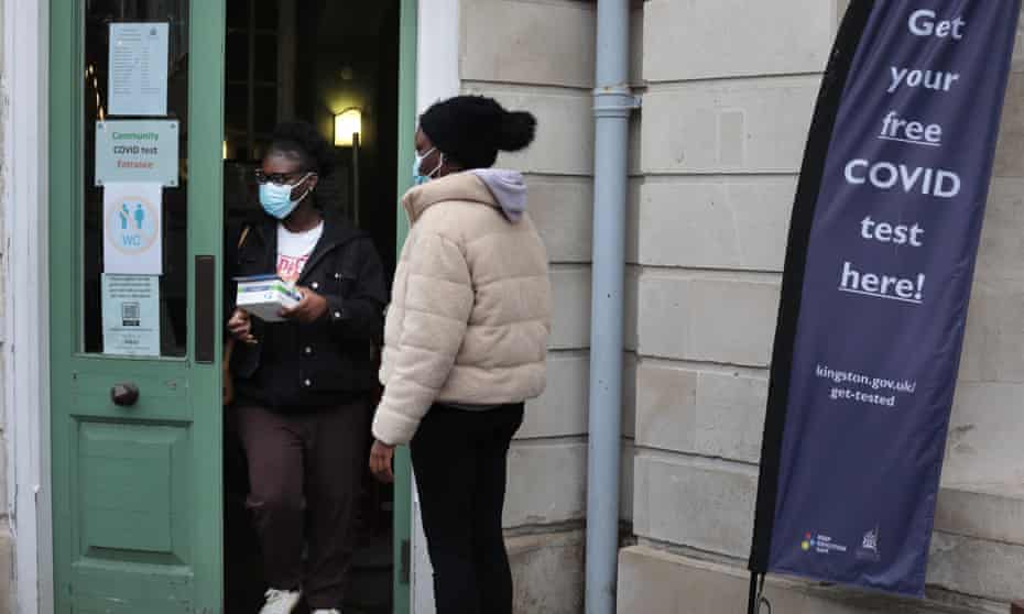 People collect free Covid-19 test kits in Kingston-upon-Thames.