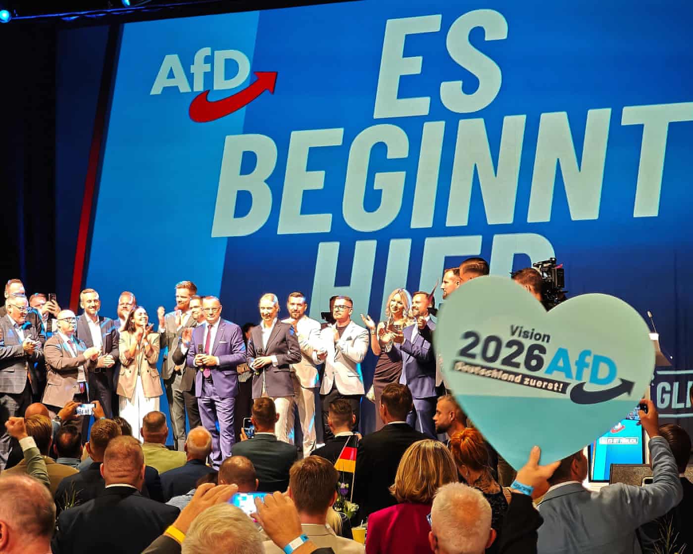 AfD leaders Ulrich Siegmund, Tino Chrupalla, and Alice Weidel, on stage at AfD election party for the 2026 state election under a slogan “It begins here.”