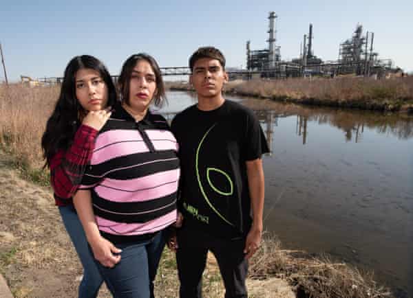 Lucy Molina and her children, Omar and Hannah, next to Sand Creek by the Suncor refinery in Commerce City, Colorado.