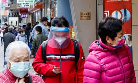 People are seen wearing face masks at the first day of a vaccine passport roll out, following the coronavirus disease (COVID-19) outbreak, in Hong Kong.