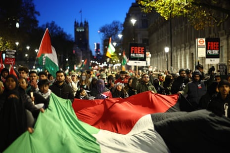 Protesters waves flags and banners as they take part in a ‘National March For Palestine’ in central London on November 25, 2023, calling for a ceasefire in the conflict between Israel and Hamas.