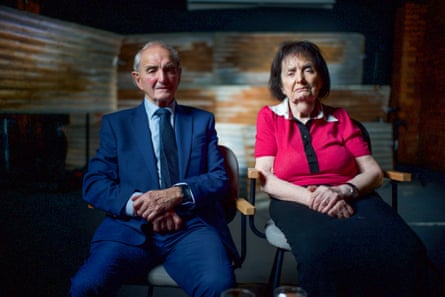 An old man and woman sitting on chairs