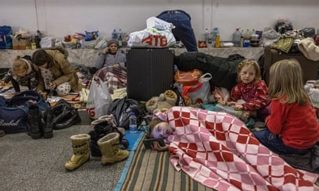 People shelter from Russian attacks in a Kyiv underground station on Wednesday.