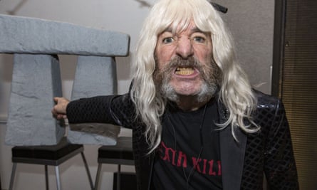 Harry Shearer as Spinal Tap bassist Derek Smalls with a miniature model of Stonehenge.