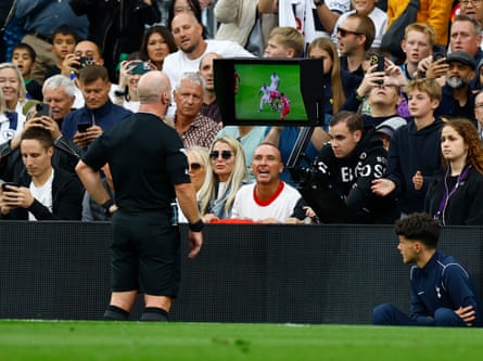 Referee Simon Hooper looks at the VAR monitor before giving Liverpool’s Curtis Jones a red card.