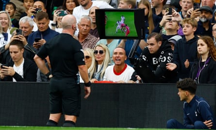 Referee Simon Hooper looks at the VAR monitor before giving Liverpool’s Curtis Jones a red card
