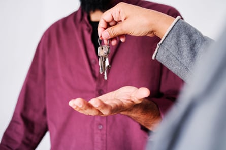 Person handing a set of keys to another person