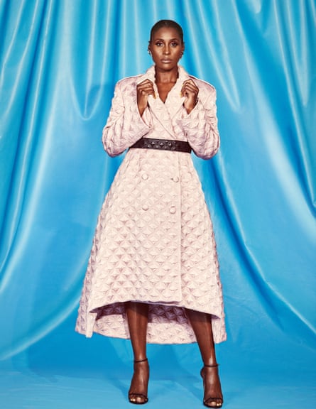 Issa Rae in a belted pale pink coat dress