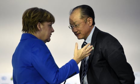 World Bank president Jim Yong Kim with German chancellor Angela Merkel in Paris.