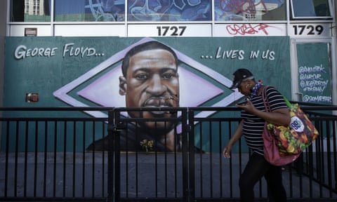 A person walks past a mural of George Floyd in Oakland, California, Thursday, 4 June 2020.