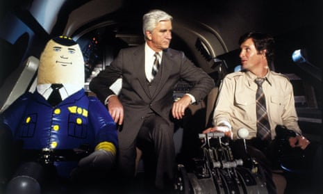 Leslie Nielsen and Robert Hays in Airplane!, a film that never pauses for a laugh, because there’s another one coming.
